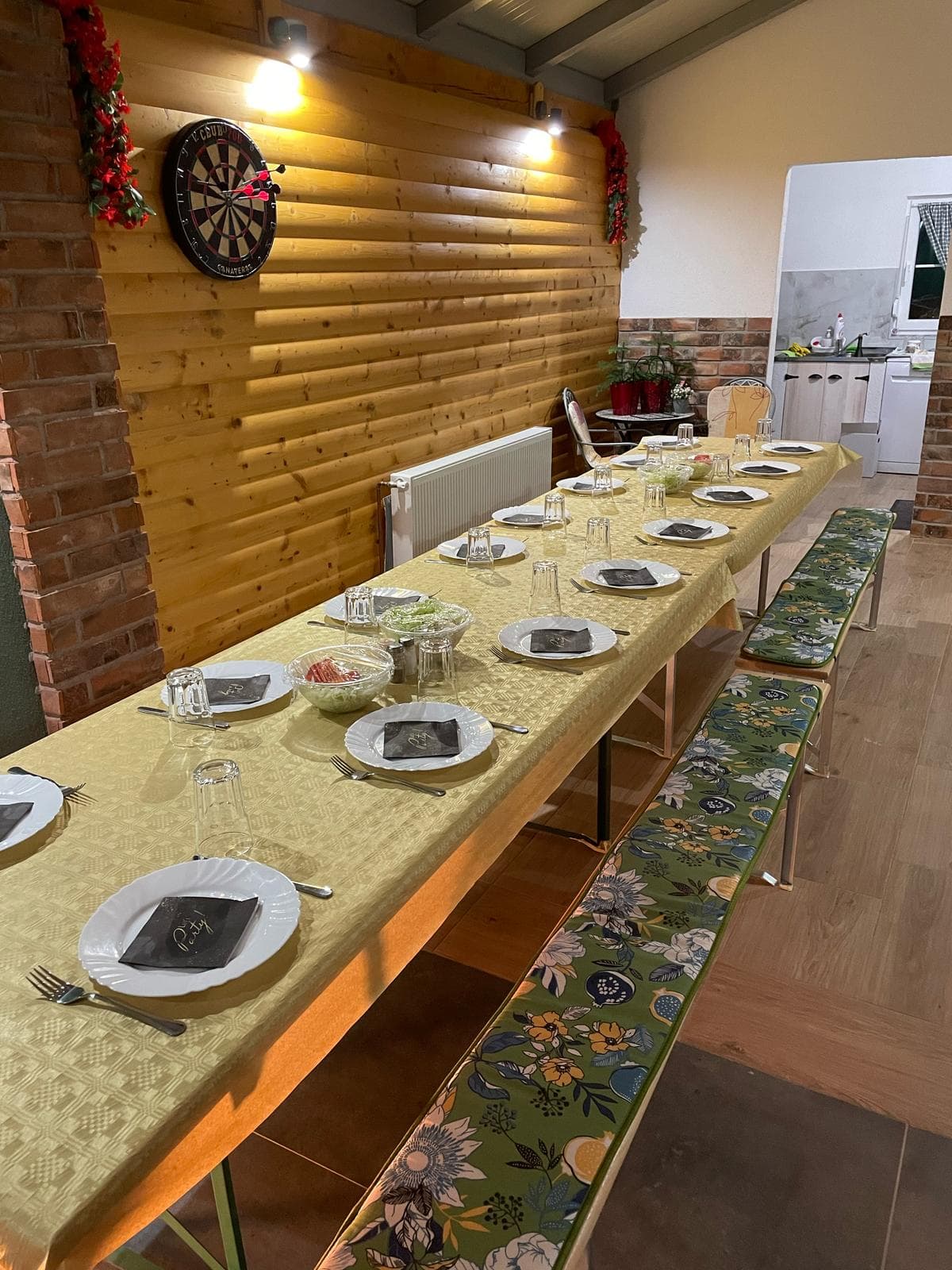 Enclosed terrace set with a long table for a celebration